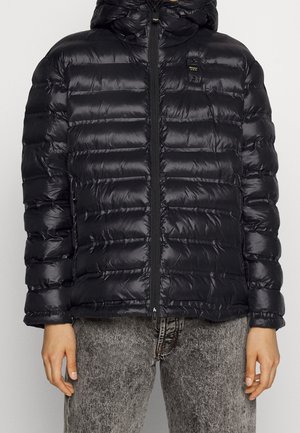 Black puffer jacket with a hood, featuring horizontal quilted texture, front zipper, and a branded badge on the upper left chest area.