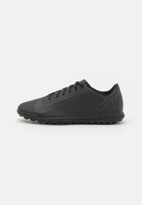 Black athletic shoe with a textured surface, flat sole, and laces. Features subtle blue accents and a streamlined, angular design.
