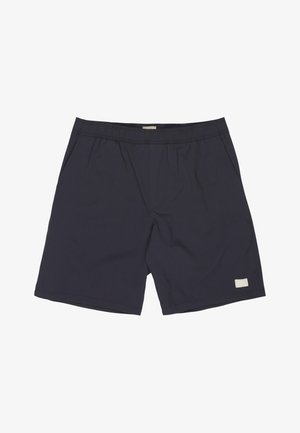 Pantaloncini casual blu navy con vita elastica, tasche laterali e piccola etichetta bianca rettangolare del marchio sull'orlo della gamba sinistra.