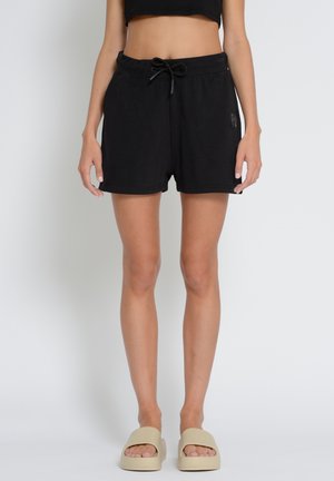 Schwarze Baumwollshorts mit elastischem Bund, Kordelzug und seitlichen Taschen. Glatte Textur; knielanges Design. Mit kleinem Logo akzentuiert.