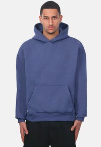 Kapuzensweatshirt aus blauen Baumwollgemisch, mit einer Fronttasche, gerippten Bündchen und gesticktem Markenlogo auf der Brust. Weiche Textur.