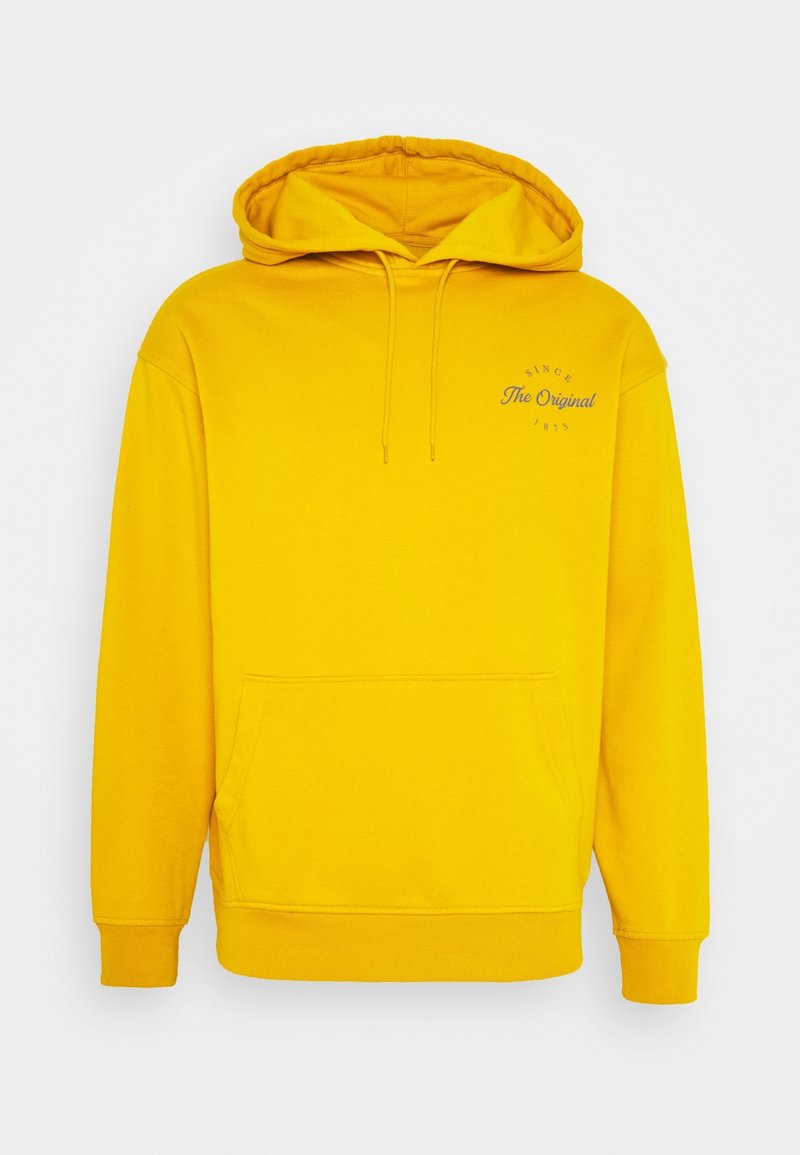 Sweat à capuche jaune à enfiler avec poche avant, cordons et petit texte « Since The Original 1873 » sur la poitrine gauche.