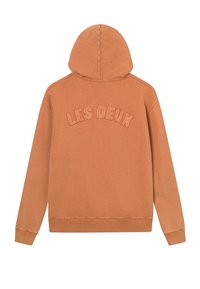 Sweat à capuche couleur rouille avec "LES DEUX" brodé en fil assorti sur le haut du dos, avec poignets et ourlet côtelés.