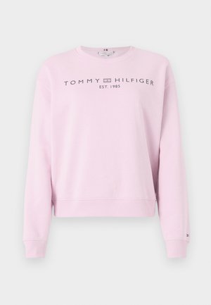 Rózsaszín pamutpulóver kerek nyakkivágással, bordás mandzsettákkal és aljjal. A mellkason középen sötétszürke "TOMMY HILFIGER" logó található.