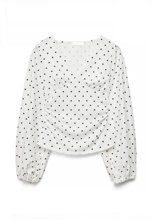 Blusa bianca a maniche lunghe con pois neri, scollo a V, davanti arricciato e polsini elasticizzati sulle maniche.