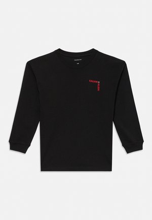 Zwart shirt met lange mouwen en ronde hals, met een rood "CALVIN KLEIN"-logo op de linkerborst en geribbelde manchetten.