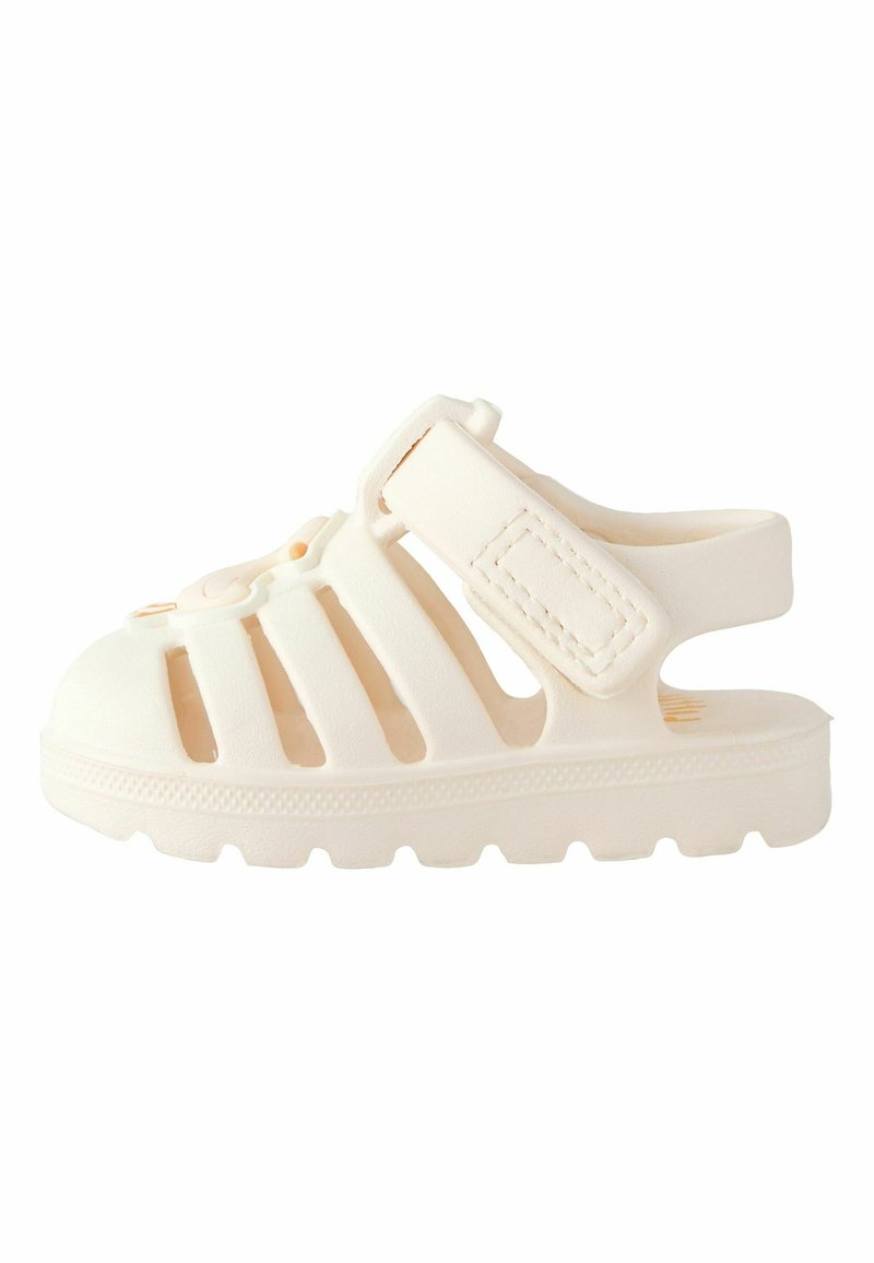 White rubber sandal with cut-out design, adjustable strap, and textured sole. Features a rounded toe and a solid, durable construction.