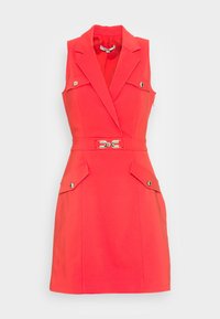 Sleeveless red dress with lapel collar, gold buttoned flap pockets, and a matching belt featuring a gold decorative buckle.