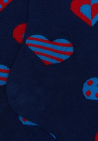 Navy socks featuring red and blue heart patterns, some with stripes and dots. Smooth texture with elasticized cuffs for a snug fit.