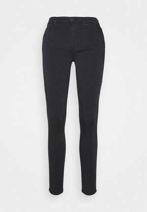 Svarta smala jeans med knäppning, dragkedja, framfickor och en mjuk yta. Åtsittande design från midja till ankel.
