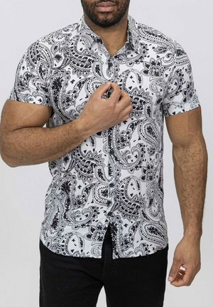 Chemise à manches courtes en motif paisley noir et blanc, dotée d'un col boutonné, d'un tissu texturé et d'une coupe ajustée.