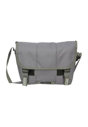 Gray messenger bag with an adjustable shoulder strap, two front buckles, and a Timbuk2 logo centered on the front flap.