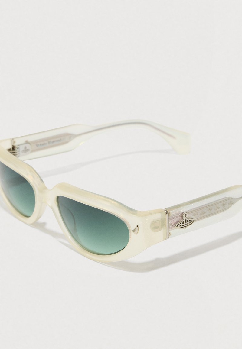 White, translucent sunglasses with green gradient lenses, a chunky design, and decorative silver hardware on the arms featuring a logo.