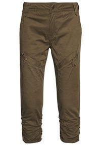 Khaki cargo kalhoty vyrobené z bavlněné směsi, s kapsami na zip, kovovými ozdobami a staženými manžetami u kotníků.