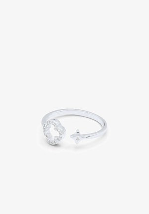Bague ouverte en argent avec une extrémité en forme d'étoile et une extrémité en forme de fleur ornée de petits cristaux clairs.