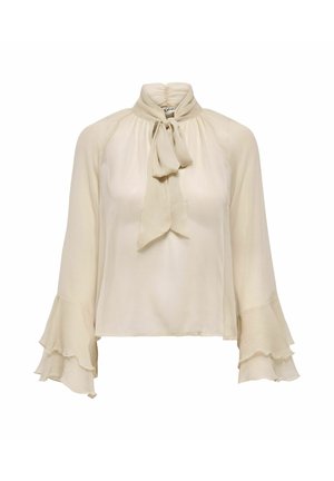 Blouse transparente de couleur crème avec col haut froncé, nœud à l'avant et manches longues évasées à volants superposés.