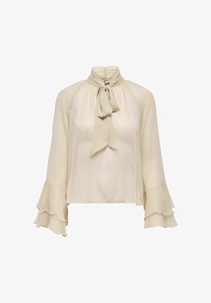 Blouse transparente de couleur crème avec col haut froncé, nœud à l'avant et manches longues évasées à volants superposés.