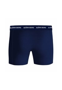 Boxer bleu marine en tissu doux, avec une coupe ajustée et une ceinture élastique arborant la marque blanche répétée "BJÖRN BORG".