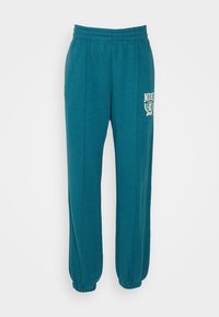 Teal Nike sweatpants tillverkade av mjukt material, med elastisk midja, avsmalnande mudd, sidokanaler och en logotyp tryckt på överbenet.