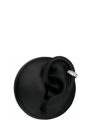 Black circular display with a silver ear cuff earring featuring small bead and rhinestone details on the upper ear rim.