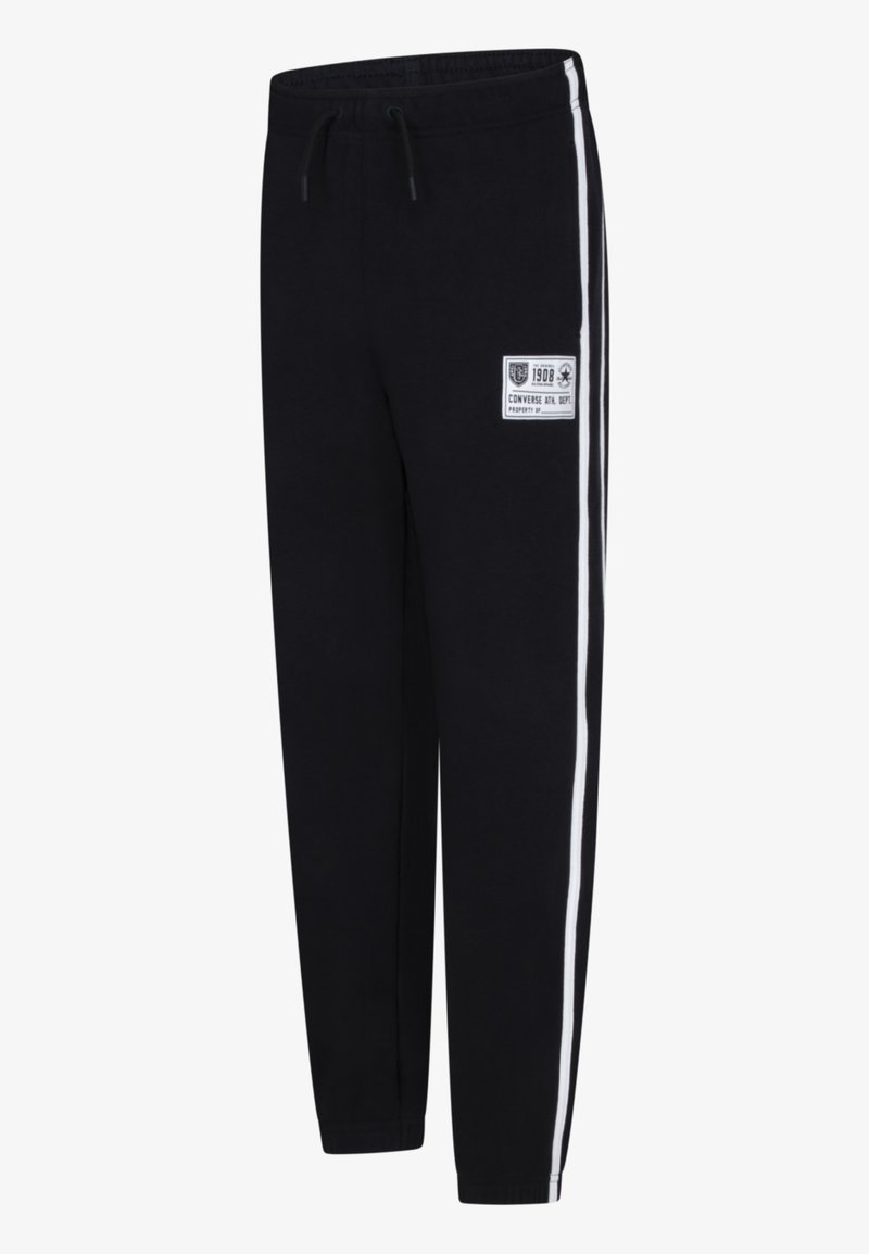 Svarta joggingsbyxor i mjukt tyg, med vita sidistripes och en logotypapplikation på framsidan. Utformade med resårmidja.