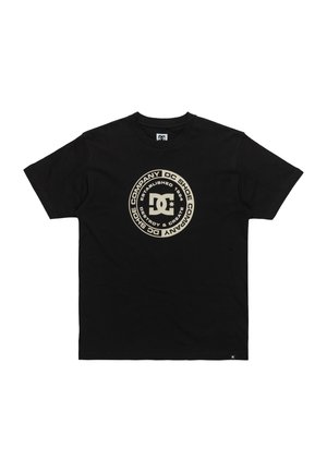 Black cotton t-shirt featuring a circular DC logo in gold, with text detailing brand name and year established. Short sleeves and crew neck.