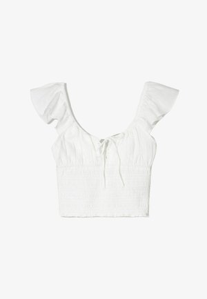 Fehér crop top, rövid fodros ujjakkal, négyzet alakú nyakkivágással és elől megkötő részletekkel. Az anyag puha, texturált, smockolt felületű.