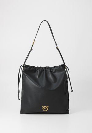 Black leather shoulder bag with gathered top, adjustable strap with gold accents, and small gold bird emblem at the bottom center.
