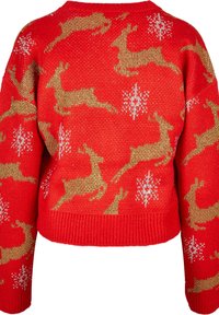 Röd stickad tröja med guldiga renar och vita snöflinge-mönster. Kort design med ribbade ärmslut och nederkant. Mjuk textur.