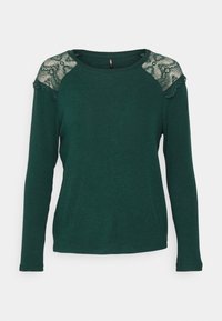 Green long-sleeve top with lace accents on shoulders; round neckline; soft texture; fitted design.