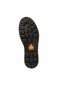 Semelle de botte en caoutchouc noir avec des sculptures profondes, arborant un logo en forme d'astérisque orange et le texte "THE ART COMPANY" sur la zone de l'arche.