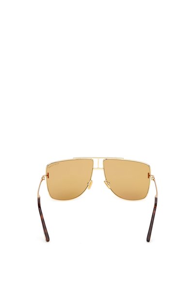 Guldmetallsolglasögon med vinklade linser, ljusbruna tonade linser och sköldpaddsarmar. Har en dubbelbrodesign.