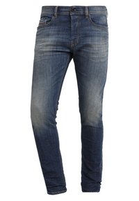 Blå slim-fit jeans med blekda detaljer, bälteöglor, framknäppning och femficksdesign.