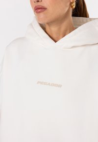 Pegador CLARITA - Camisola - washed warm white gum