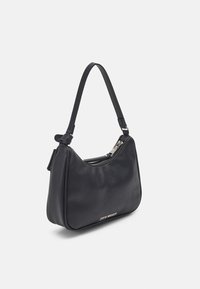Black leather handbag with a curved shape, a single shoulder strap, and a zippered top closure. Features subtle logo detail on the front.