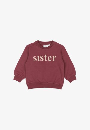 Maroon dukserica od mekog materijala, sa riječju "sister" ispisanom bež izvezenim tekstom, rebrastim manžetama i okruglim izrezom.