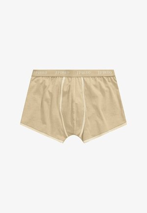 Boxer en beige en coton avec une ceinture élastique douce étiquetée "JP1880." Présente un devant cousu avec des coutures crème contrastantes.