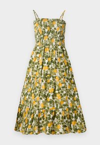 Robe sans manches avec un corsage froncé, ornée d'un motif floral vert et blanc agrémenté de citrons jaunes. Jupe évasée à volants.