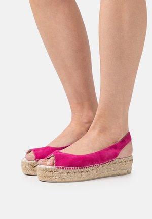 Fuchsia suede espadrille shoes with peep toe and slingback design, featuring a woven jute platform sole. Smooth texture, casual style.