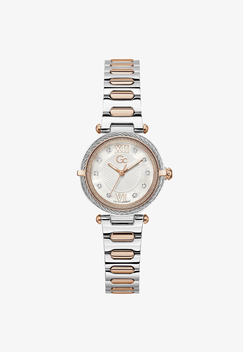 Sølv- og rosaguldfarvet ur med rund urskive, hvid tekstureret skive, romertal, krystalaccenter og en kædet metalrem.