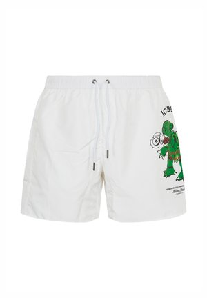 White drawstring shorts featuring a green cartoon zombie graphic and black text on the right leg, elastic waistband, and metal eyelets on drawstring.