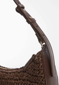 Sac à main marron tissé avec un corps texturé tressé, des accents en cuir lisse et une sangle à boucle. Comprend un détail de fermeture éclair.