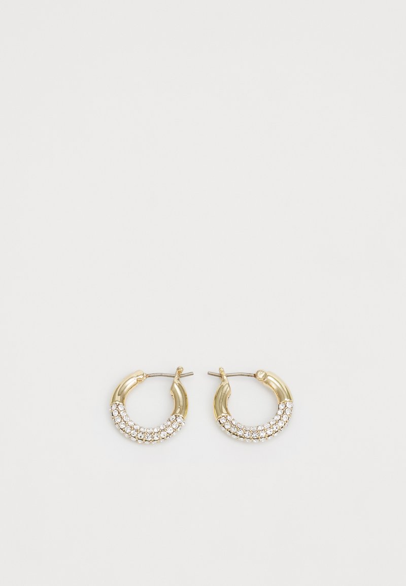 Zlatne okrugle naušnice s zakrivljenim oblikom, koje imaju red prozirnih kristala duž donjeg ruba za dodatne detalje.