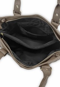 Sac à main en cuir marron avec un extérieur texturé. Il comprend un intérieur en tissu noir, plusieurs poches et des fermetures éclair pour un rangement sécurisé.