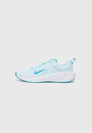 Light blue athletic shoe with a smooth fabric upper and white sole, featuring a turquoise logo and accents. Minimalist design.