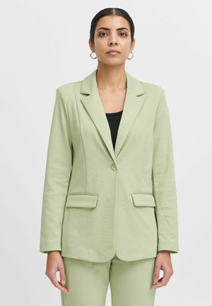 Světle zelený blazer z texturovaného materiálu, s jedním knoflíkem, dvěma předními kapsami, přiléhavým střihem, klopovým límečkem a dlouhými rukávy.