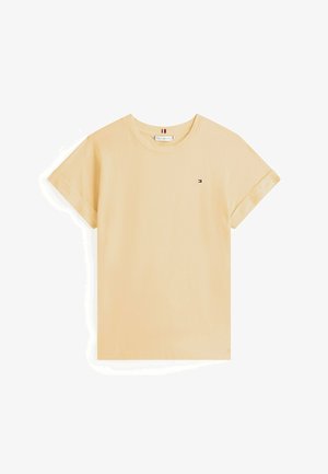 T-shirt à manches courtes et col rond en coton doux jaune pâle. Présente un petit logo sur la poitrine gauche et des manches à revers.