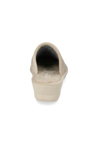 Scarpa beige slip-on con retro arrotondato, morbida fodera in tessuto, suola leggera e dettaglio testurizzato sulla parte superiore. Nessun hardware visibile.