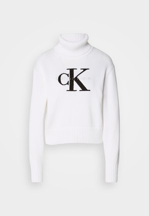 White turtleneck sweater made of knit fabric. Features a cropped design, ribbed cuffs and hem, with a black "CK" logo on the front.