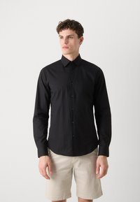 Black long-sleeve shirt made of smooth fabric, featuring a button-down collar and matching buttons, with a tailored fit and subtle sheen.